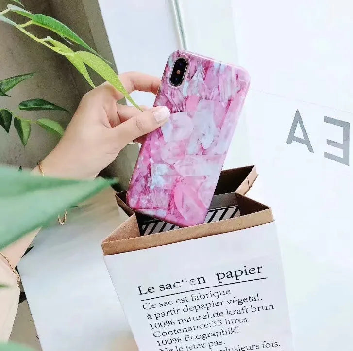 Colourful stone pattern soft back cover case for iPhone on a table.