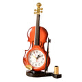 Brown plastic violin pen inserted alarm clock with quartz movement and LED display on a desk