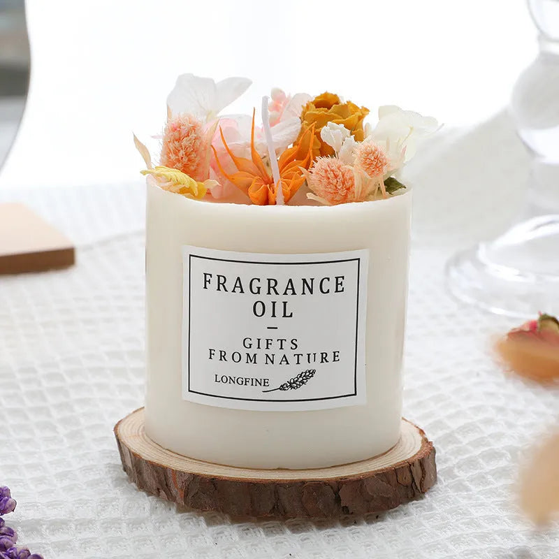 Aromatherapy candle with dried flowers on surface, shown in gift box with chip base.