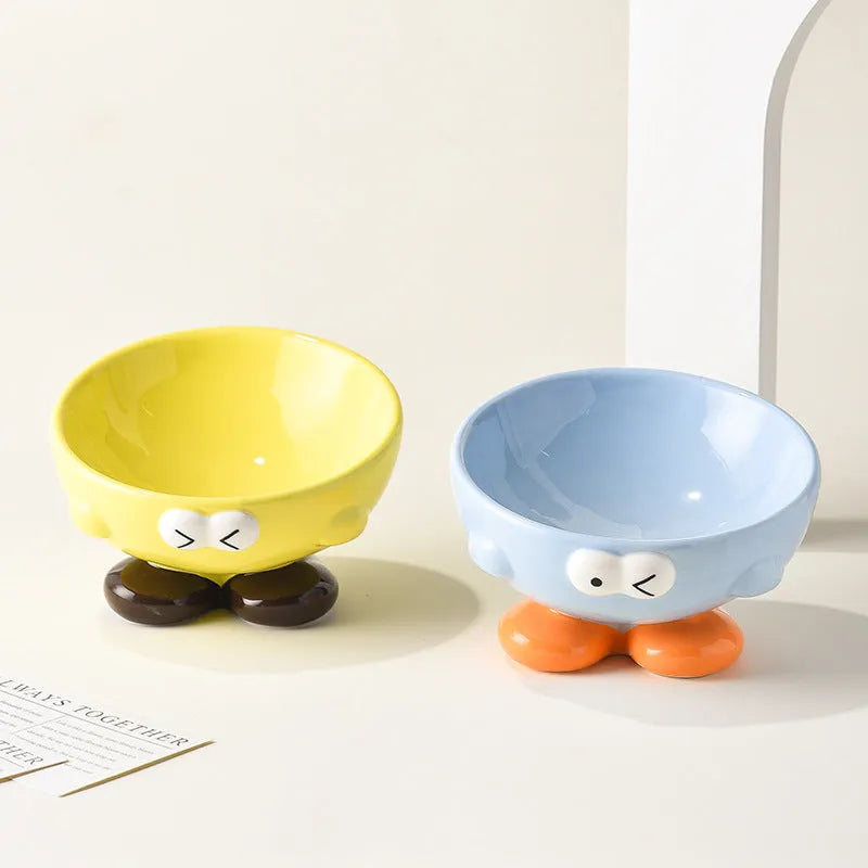 Tall blue ceramic slanted pet bowl with cute expression, designed for cervical spine support.