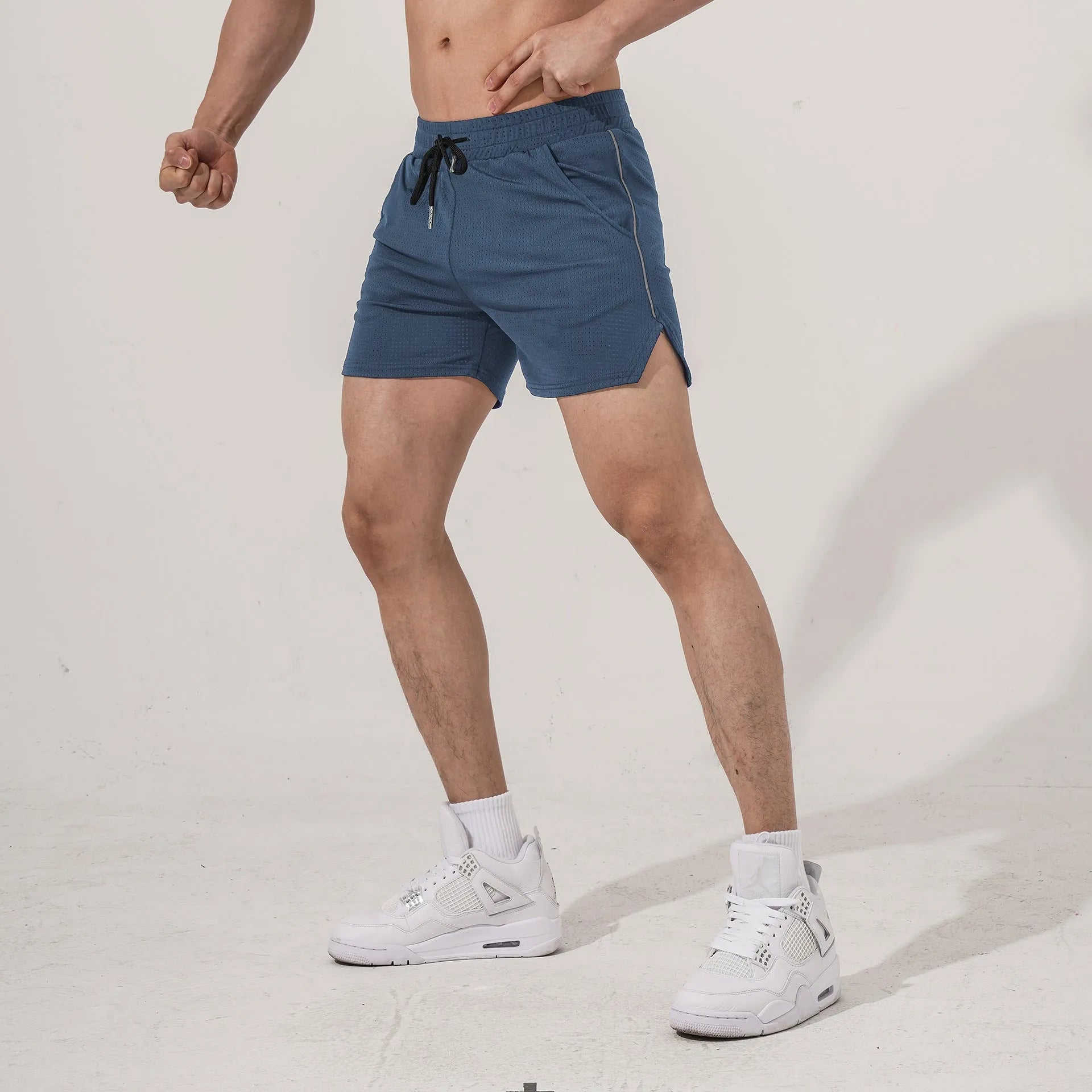 Men's straight cut polyester sports shorts in black, grey, navy, and red colours.