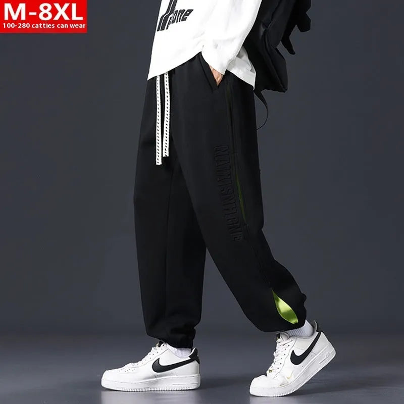 Men's loose fit cotton pants with elasticated ankle bands in grey green colour, showing collage stitching detail.