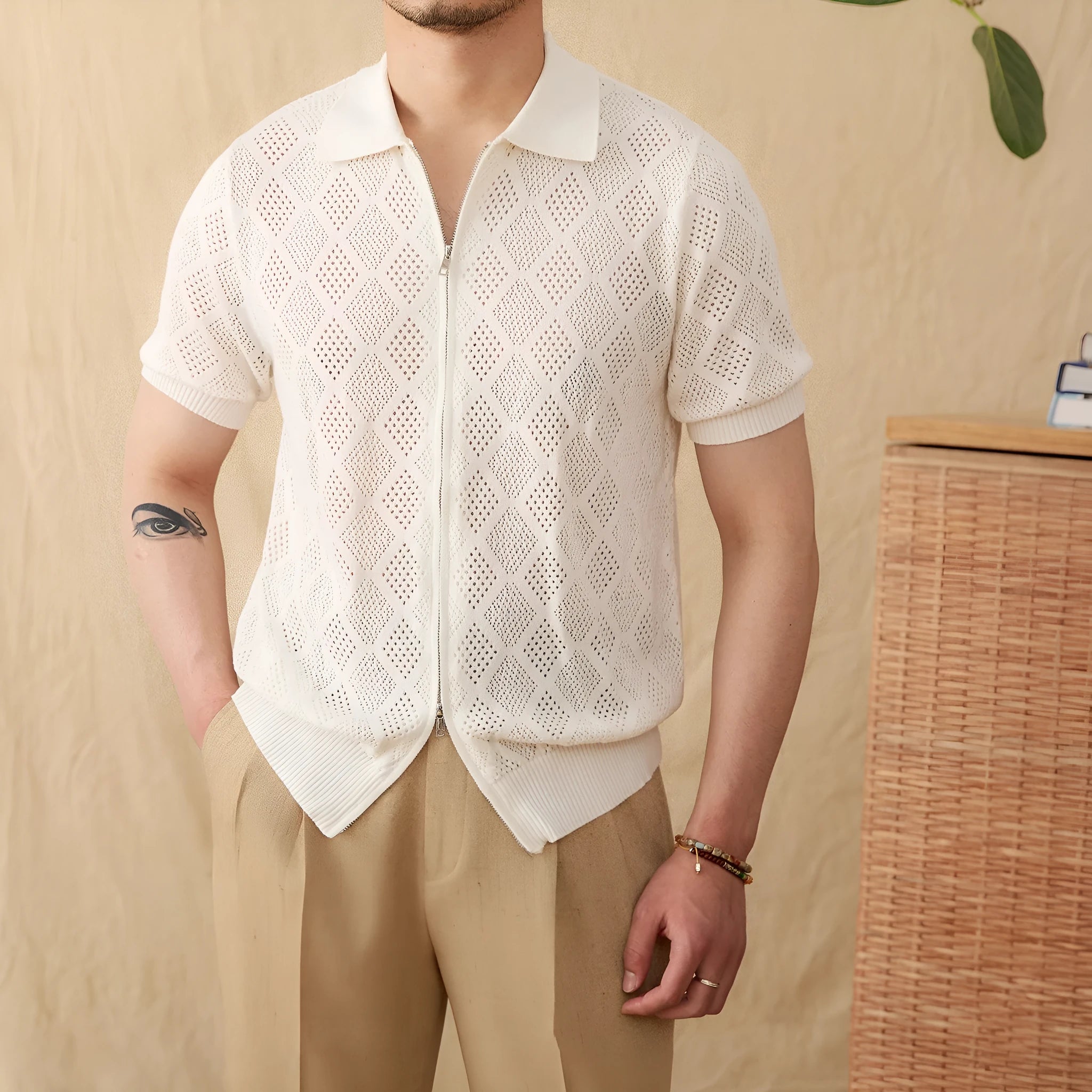 Light brown cotton short sleeve cardigan with a front zipper and lapel collar laid flat.