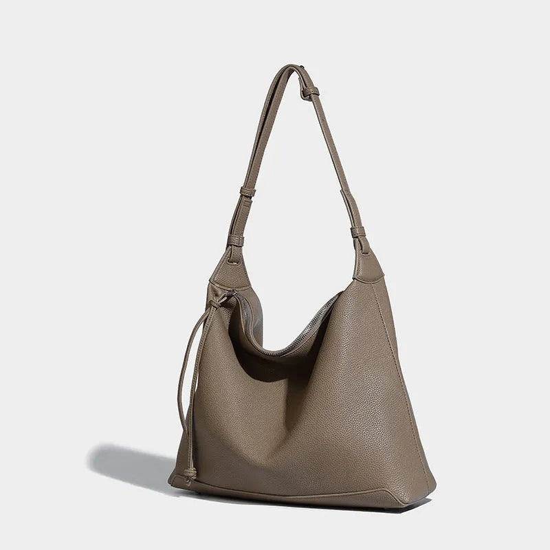 Soft PU leather messenger bag in caramel colour showing large capacity and shoulder strap.