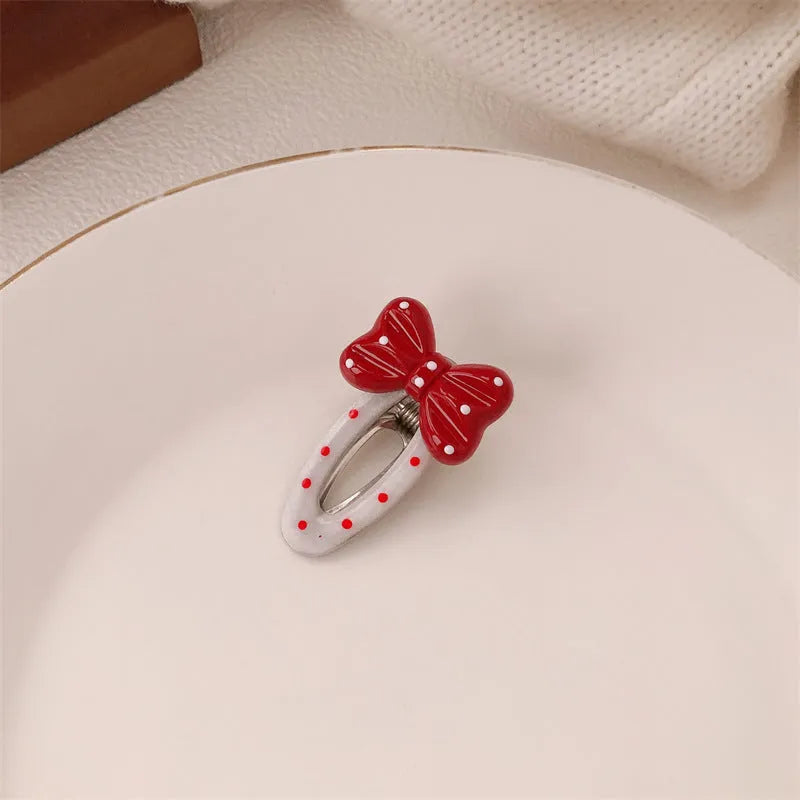Red love heart-shaped plastic hair clip with retro dots and a willow leaf silhouette on a white background.