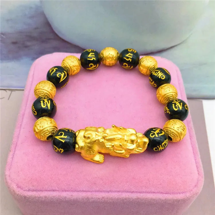Vietnamese sand gold gold-plated brave bracelet with black beads on display