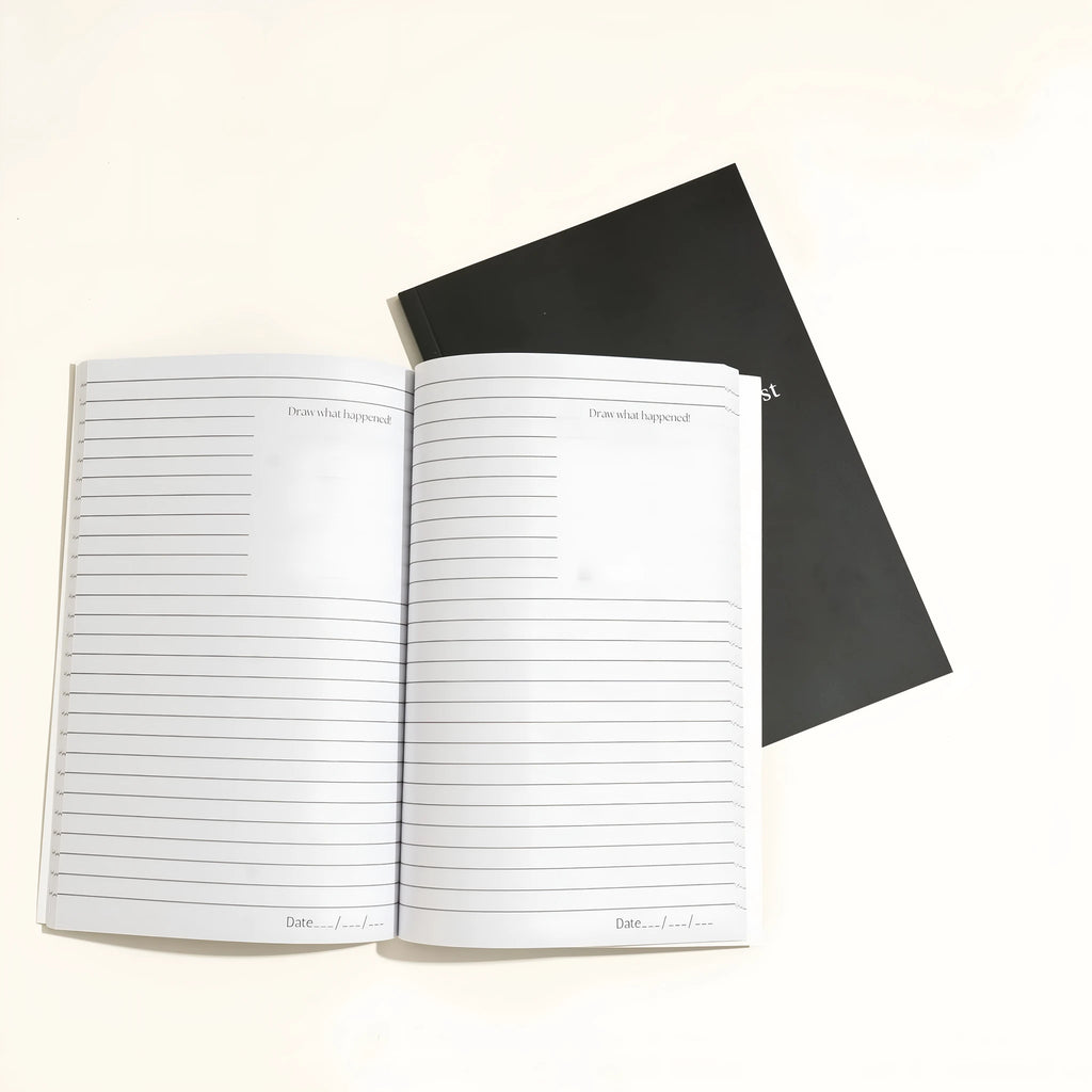 Black Dream Journal notebook with a business-simplicity design, open on a surface.