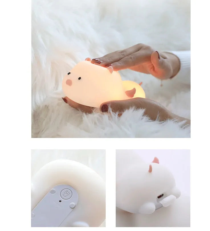 Blue silicone pig-shaped night light with sleeping design and USB charging port