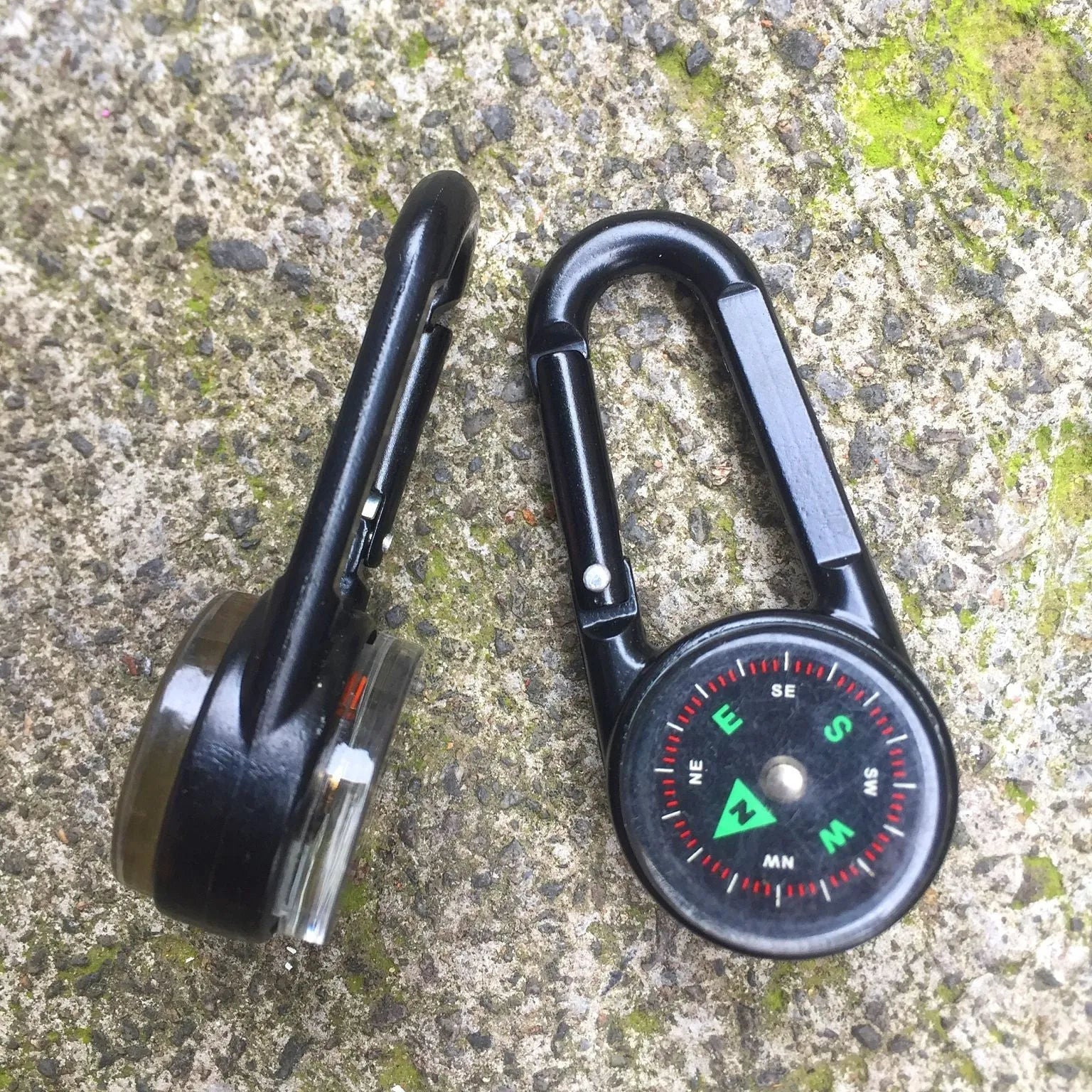 Army green zinc alloy outdoor carabiner with built-in fluid compass and liquid thermometer showing temperature scale