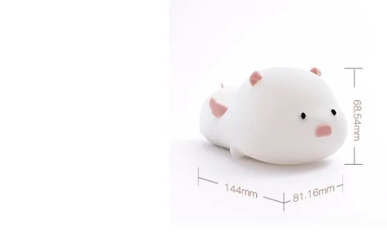 Blue silicone pig-shaped night light with sleeping design and USB charging port