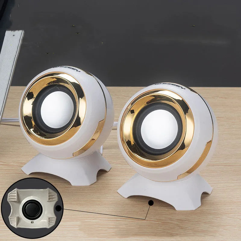 Compact black and gold desktop computer speakers with USB cable