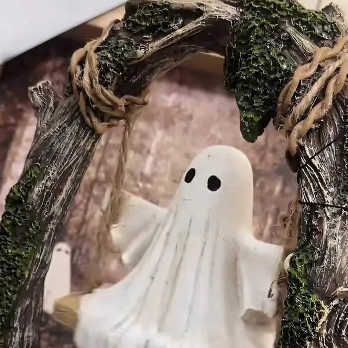 Modern Halloween decoration featuring a stylised white resin ghost on a black swing frame, with two design options shown.