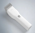 Black and white cordless men's hair clipper with ceramic cutter head and adjustable comb.