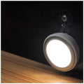 Compact round motion sensor LED light with 80mm diameter, shown in a wardrobe setting.