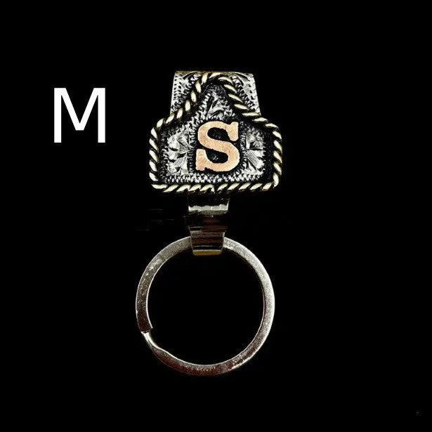 Handmade metal cow tag style key holder shown in one of its 26 colour options, attached to a keyring.