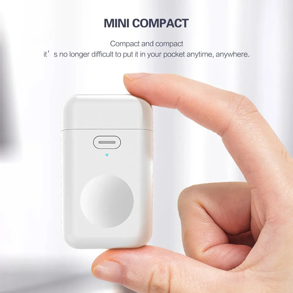 White mini magnetic portable charger for Apple Watch next to an Apple Watch on a table.
