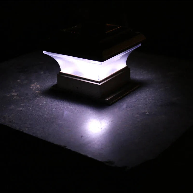 Outdoor solar column headlight XNZ-0012 in white light mode on a garden pillar