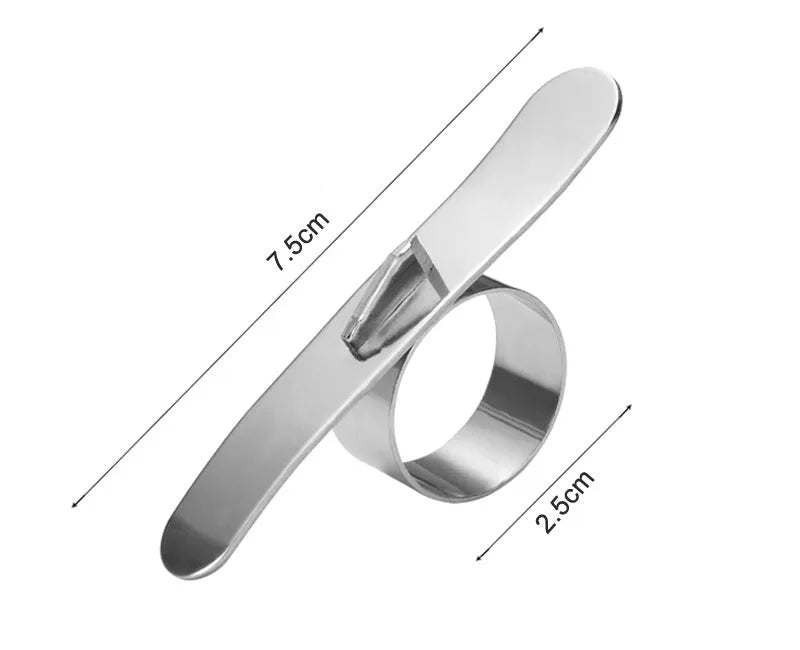 Silver stainless steel citrus fruit peeler with a ring-shaped handle on a kitchen surface.