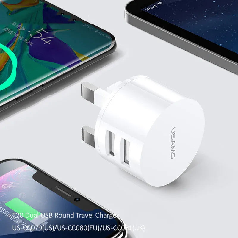 White portable universal dual USB phone charger showing US, EU and UK plug compatibility