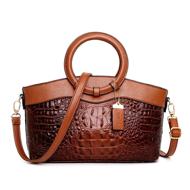 Ladies fashion handbag in multiple colours showing zipper compartments and shoulder strap