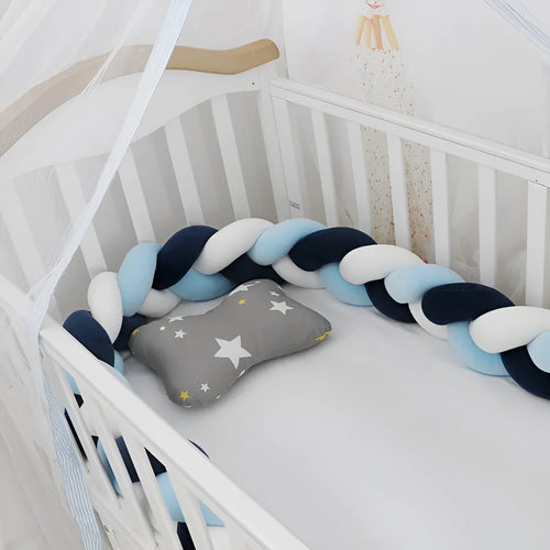 Baby cot bumper braid in spandex crystal velvet, shown in a light grey colour, wrapped around white crib rails.