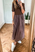 Woman wearing a coffee-coloured knitted patchwork dress with high waist and short sleeves
