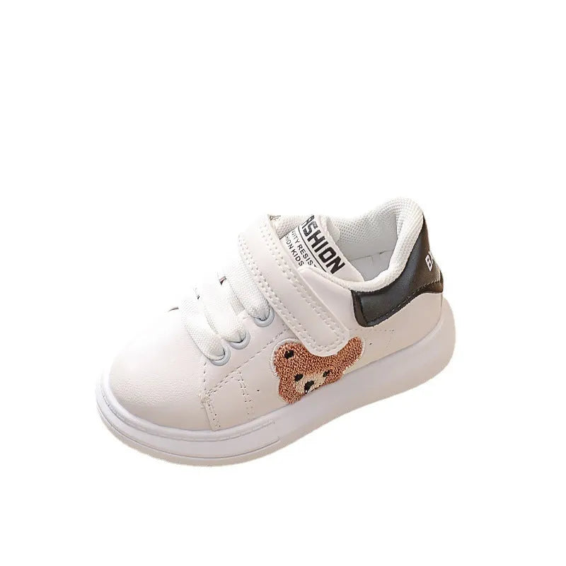 Children's black cartoon bear casual sports shoes with artificial leather upper and rubber sole.