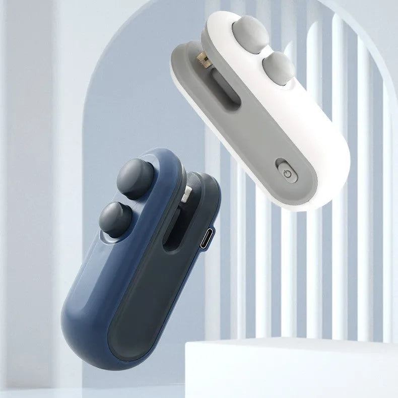 Blue and white handheld USB rechargeable heat sealer with magnetic back on a metal surface.
