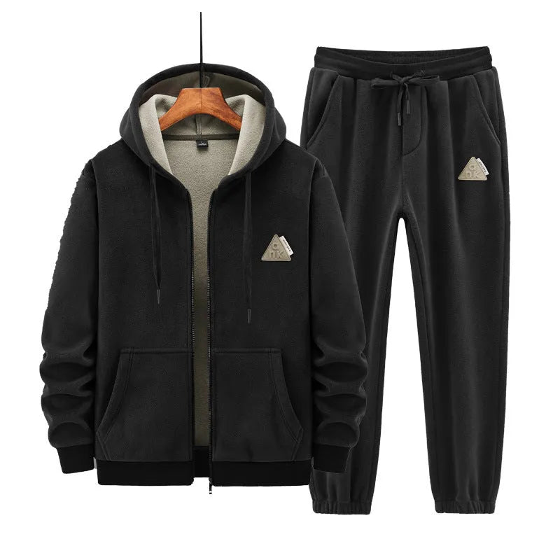 Grey cashmere hooded sportswear suit with long sleeves and matching trousers on a hanger