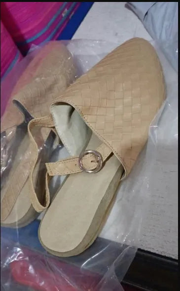 Women's black flat sandals with a buckle fastening and pointed toe on a rubber sole.