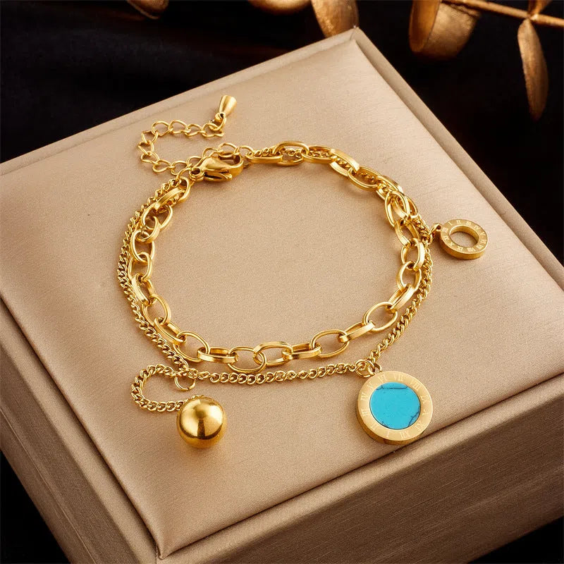 Gold plated titanium steel double layer snake chain bracelet with five-pointed star detail on display