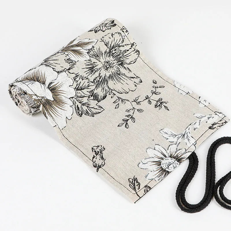 Black peony floral print canvas pencil roll bag unrolled to show 24 or 72 holes for pens.