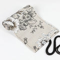 Black peony floral print canvas pencil roll bag unrolled to show 24 or 72 holes for pens.
