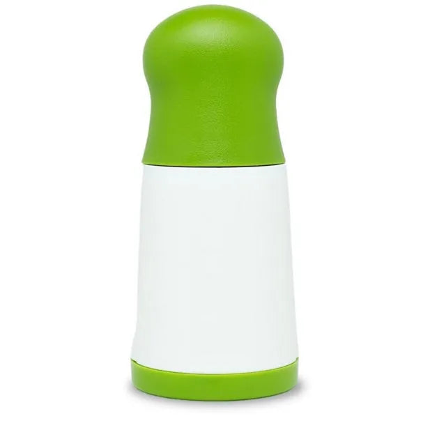 White and silver herb grinder spice mill with removable top on a kitchen counter.
