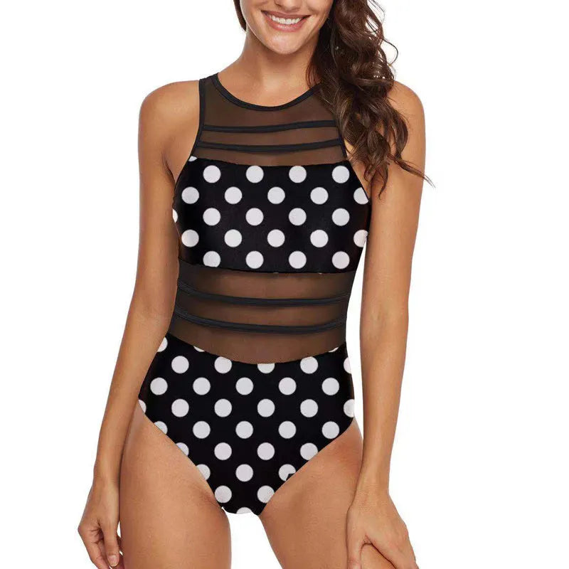 Women's black mesh turtleneck swimsuit with open back design lying flat