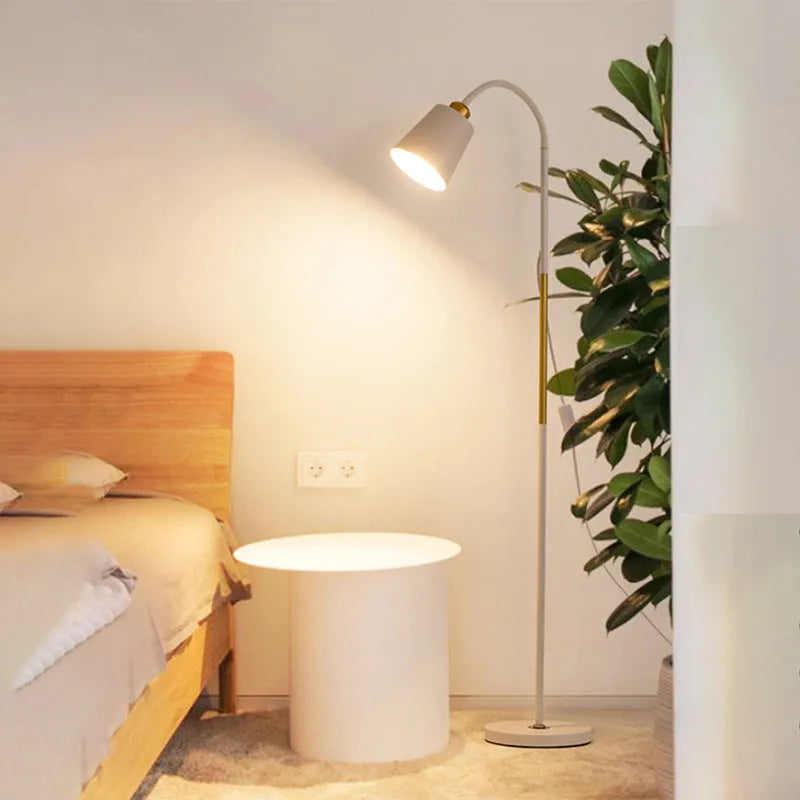 Nordic style black and gold floor lamp with eye-protection LED light next to a sofa.