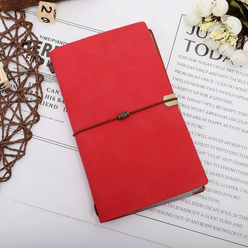 A6 imitation leather notebook with cowhide rope decoration, open to show flat-lying wireless binding.
