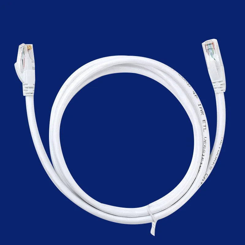 White Cat6 network cable with RJ-45 connectors on both ends lying on a flat surface
