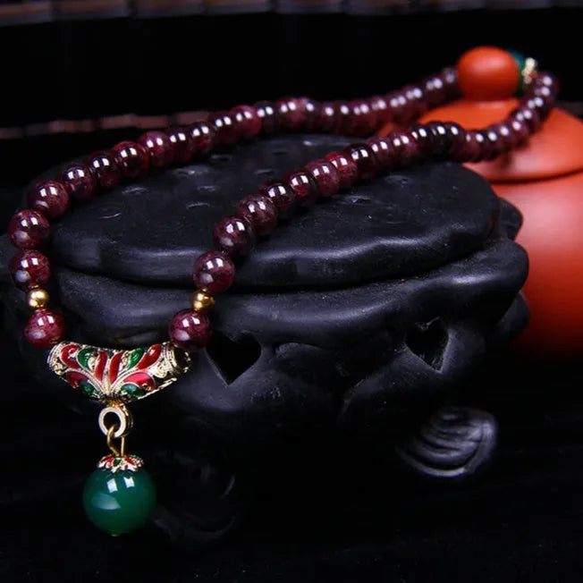 Natural garnet bracelet with 7mm beads, golden toad charm and adjustable double-ring clasp
