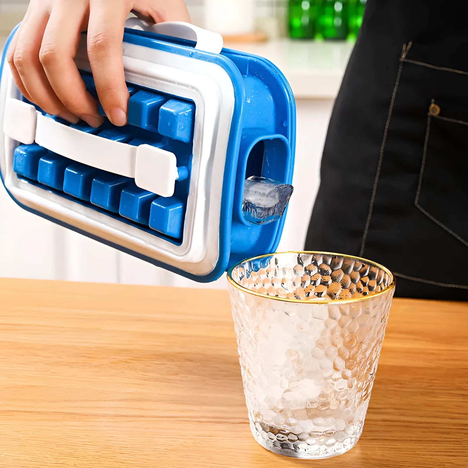 Blue silicone ice cube tray with 36 square cavities and a lid on a wooden table