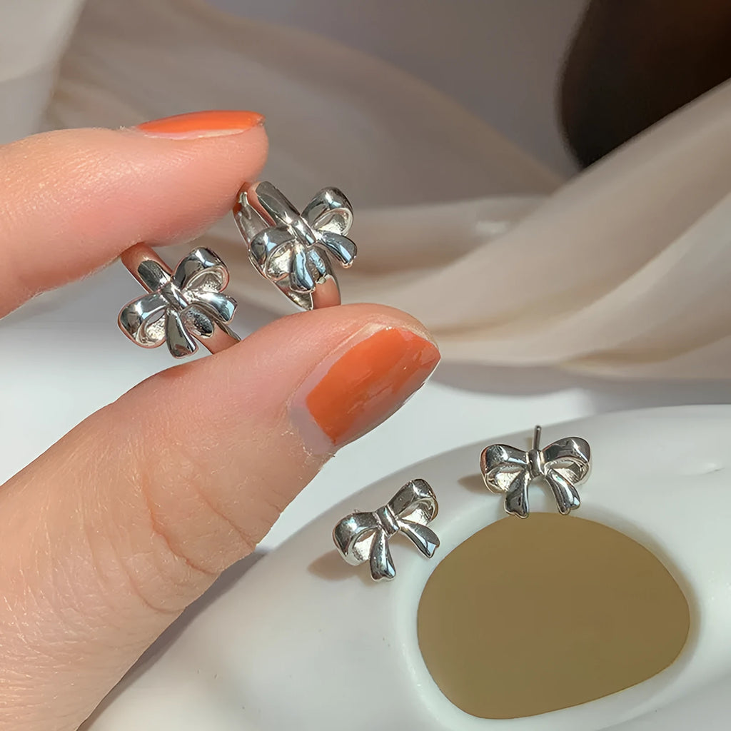 925 sterling silver bow earrings for women with silver electroplated finish on a white background
