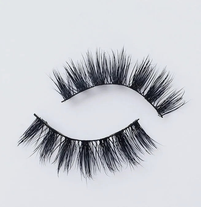Pair of faux mink eyelashes with long tail and cotton stem against white background