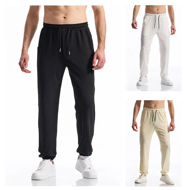 Men's black silky rib fabric casual trousers with baggy straight leg and elastic waistband