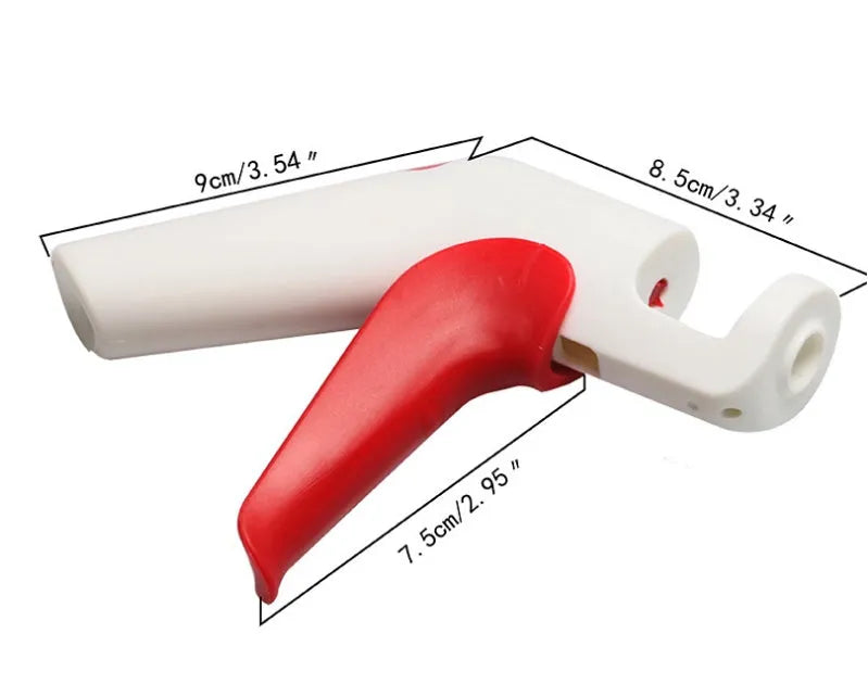 Red and white stainless steel manual cherry kernel remover pitter on a clean surface