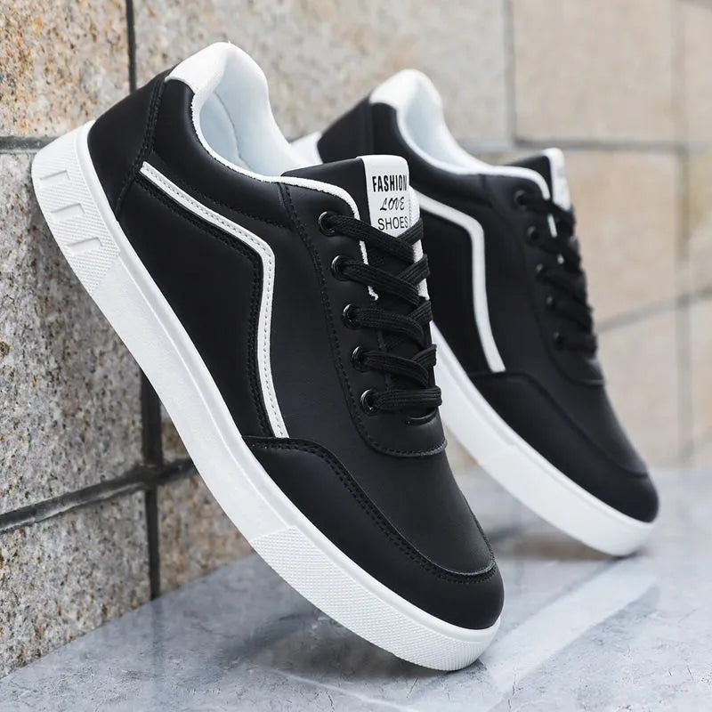 Men's low-top Korean style board sneakers in black with round toe, flat heel, and sewing line detail on the upper.