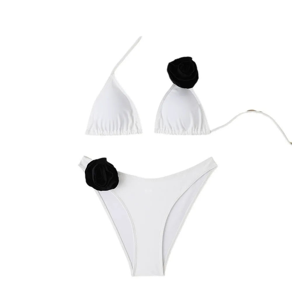 Women's nylon triangle bikini with three-dimensional white flowers, black solid colour, and lace-up split side briefs