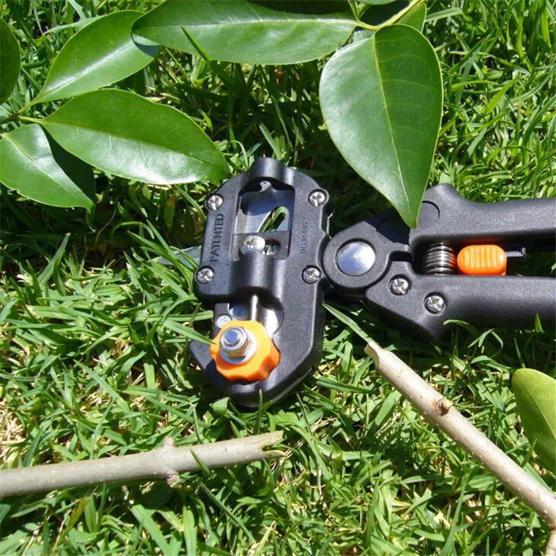 Black handheld grafting scissors with high carbon steel blade and ABS handle on a wooden surface