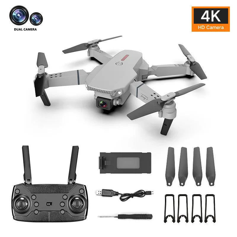 Grey foldable 4K dual camera aerial drone with remote control and spare blades