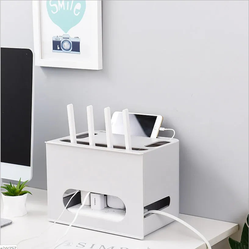 Grey and white plastic wireless router storage box with cable slots and ventilation holes.