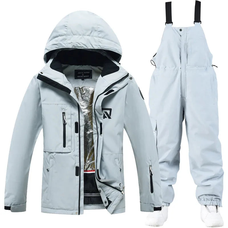 Man and woman modelling a blue and black waterproof ski suit for winter snow sports.